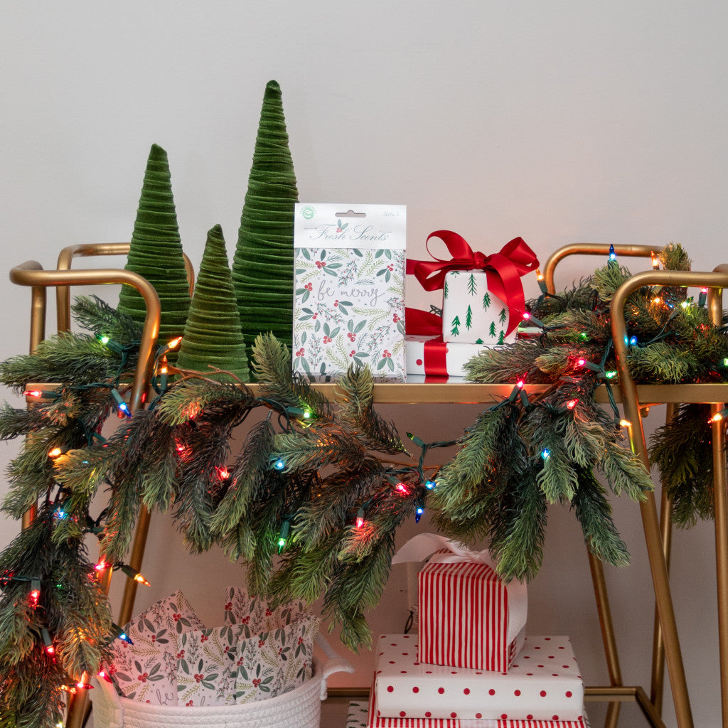 Be Merry Fresh Scents Scented Sachet on holiday decorated bar cart with pine garland and wrapped presents