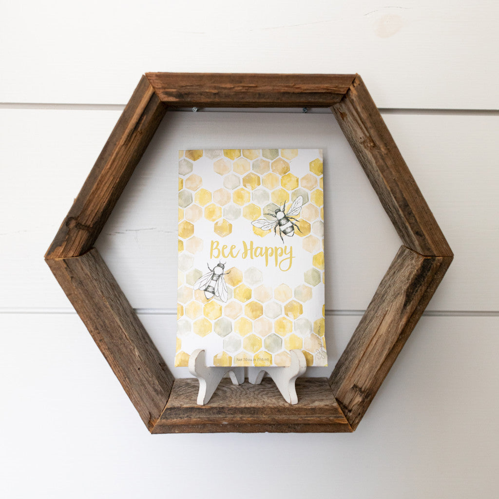 Bee Happy scented sachet sitting on hexagon shelf