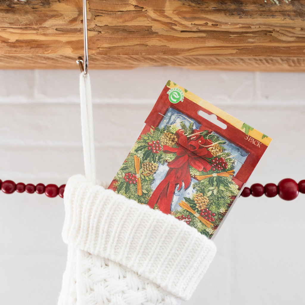 Red Door Wreath Fresh Scents scented sachets in white Christmas stocking on mantle