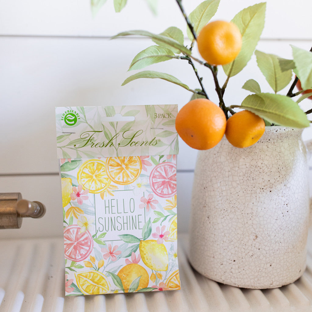 Hello Sunshine Citrus Fragrance Sachet Next to Vase with Orange Stems