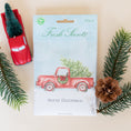 Load image into Gallery viewer, Merry Christmas Fresh Scents scented sachets flat lay with pine needles and red model truck.
